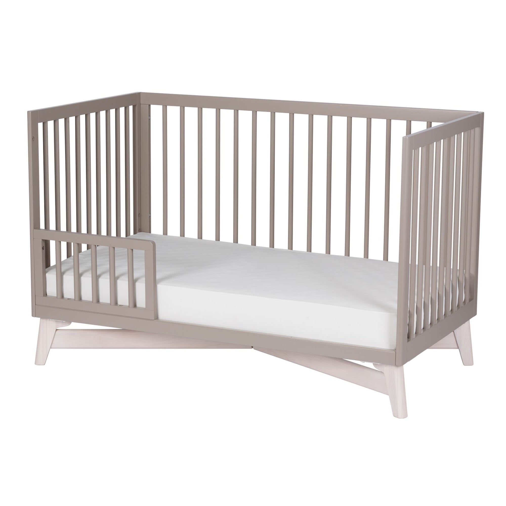 Solid New Zealand pine toddler guardrail with round spindles for converting the Pala crib into a secure toddler bed.