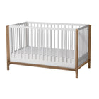 Modern two-tone 4-in-1 convertible crib made of solid New Zealand pine that supports children from birth up to 50 lbs.