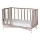 Solid New Zealand pine toddler guardrail with round spindles for converting the Pala crib into a secure toddler bed.