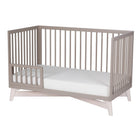 Solid New Zealand pine toddler guardrail with round spindles for converting the Pala crib into a secure toddler bed.