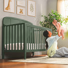 Lifestyle image of a mom and baby enjoying the crib. 