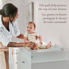 Lifestyle image highlighting the felt pads on the underside of the topper that protect the dresser surface.