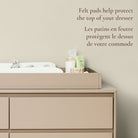 Lifestyle image highlighting the felt pads on the underside of the topper that protect the dresser surface.