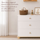 Lifestyle image of the Roo nursery dresser showcasing three deep, staggered storage drawers with natural wood knobs.